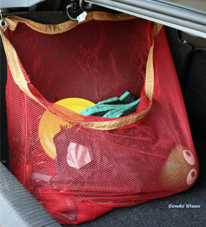 red net organizer holding sports equipment in the car