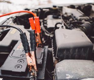 jumper cables hooked up to your car's engine