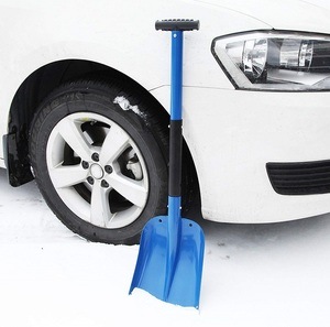 Blue Portable Snow Shovel by Cartman sitting next to a white car